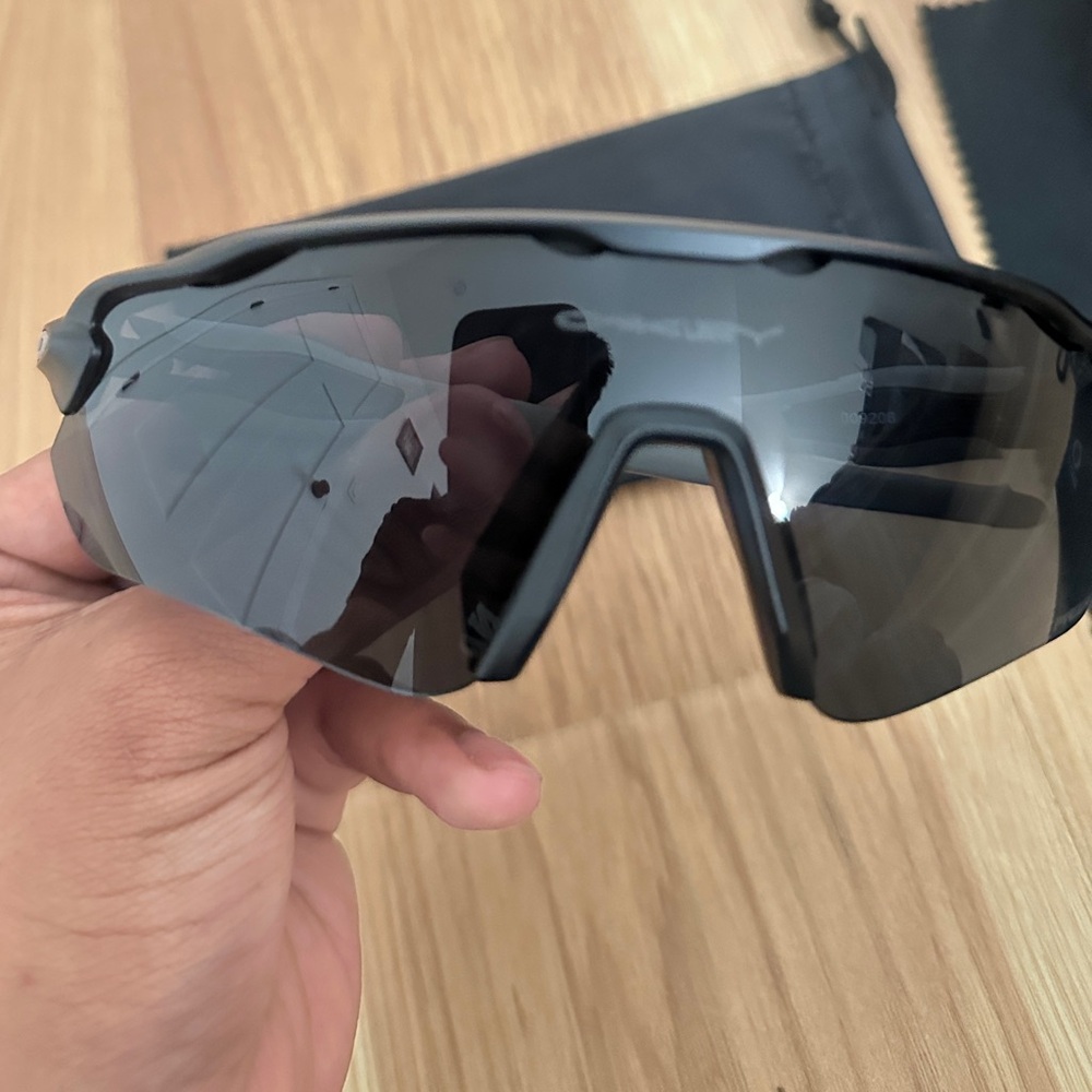 Black Oakleys sport glasses grey legs black visor